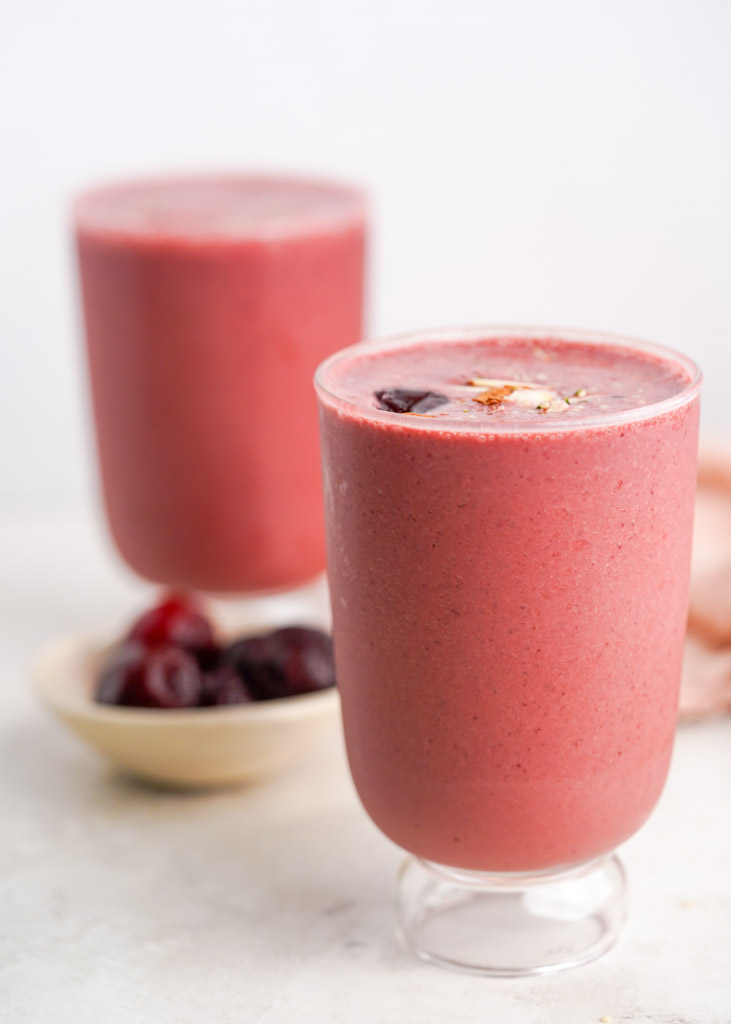 two cups filled with cherry smoothie