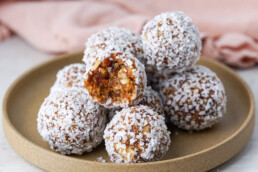 plated date balls with one bitten into to reveal the chewy center