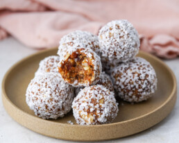 plated date balls with one bitten into to reveal the chewy center