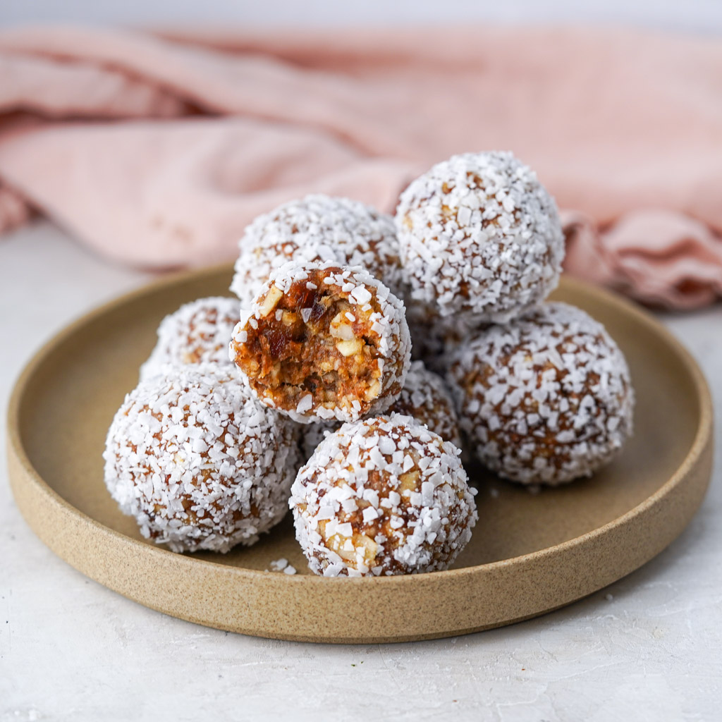 plated date balls with one bitten into to reveal the chewy center