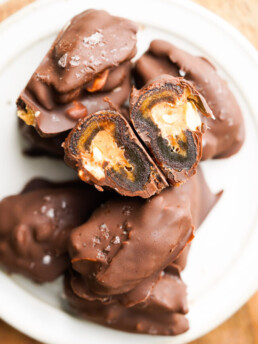 plated date snickers with one sliced open to reveal the center