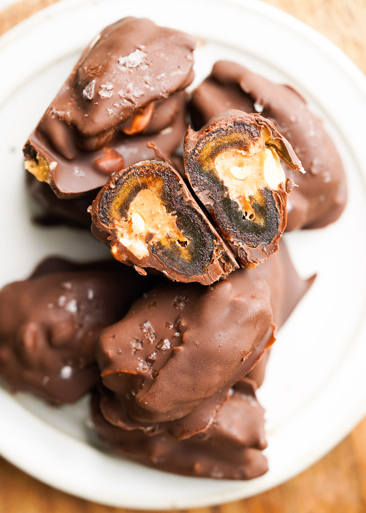 plated date snickers with one sliced open to reveal the center