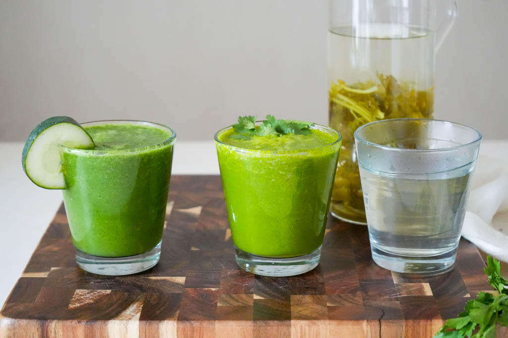 three cilantro drinks on a cutting board