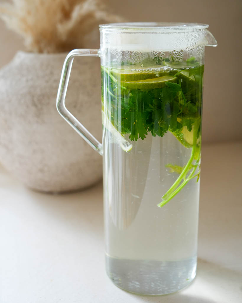 cilantro steeped in a large glass pitcher