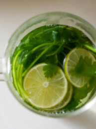 cilantro in a large glass with lime