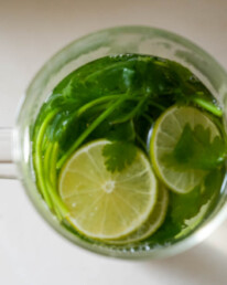 cilantro in a large glass with lime