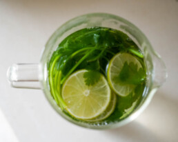 cilantro in a large glass with lime