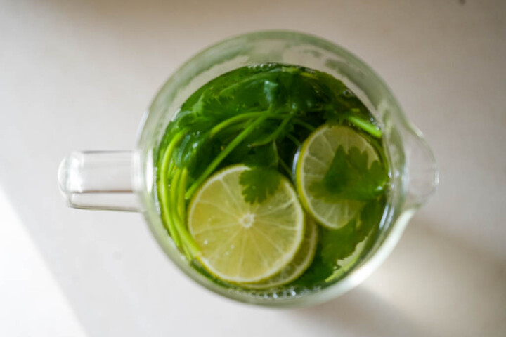 cilantro in a large glass with lime